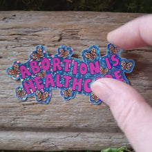 Load and play video in Gallery viewer, "Abortion is Healthcare" Glitter Sticker