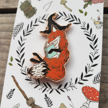 Load image into Gallery viewer, Enamel pin of a magical fox in a witch hat, reading a book.
